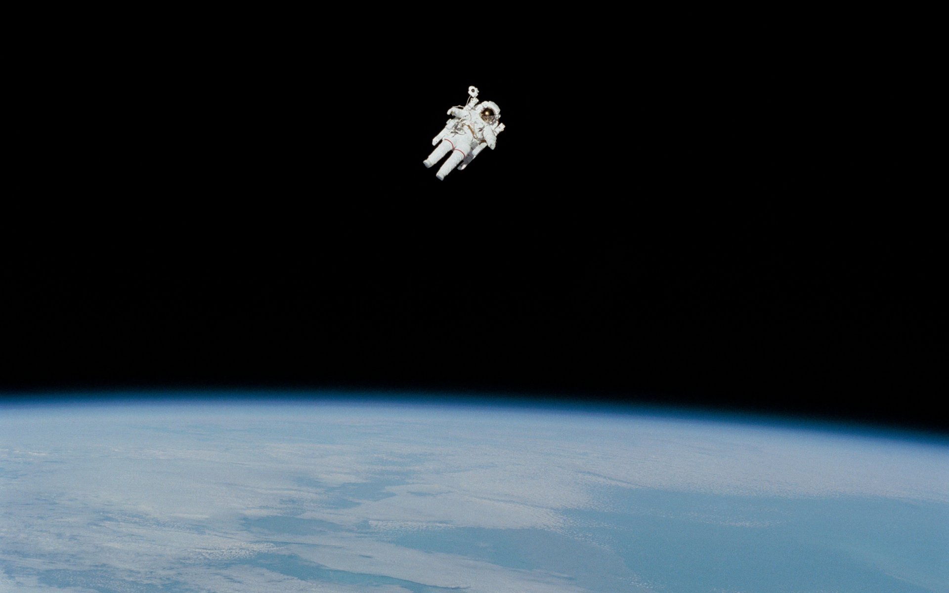 Ein Astronaut schwebt im Weltall, im Hintergrund kann man die Erde erkennen.